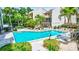 Beautiful community pool and sundeck area surrounded by lush landscaping at 6157 Midnight Pass Rd # E65, Sarasota, FL 34242