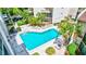 Large community pool surrounded by lush landscaping and comfortable lounge chairs for relaxation at 6157 Midnight Pass Rd # E65, Sarasota, FL 34242