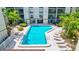 Community pool surrounded by lush greenery, offering a refreshing escape for residents at 6157 Midnight Pass Rd # E65, Sarasota, FL 34242