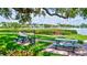 Community space with picnic benches and grills next to a waterfront view at 6157 Midnight Pass Rd # E65, Sarasota, FL 34242