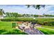 Community space with grills, benches, and manicured landscaping next to the water at 6157 Midnight Pass Rd # E65, Sarasota, FL 34242