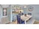 Bright dining room features modern table, chairs, and a pass-through to the kitchen area with stainless appliances at 6157 Midnight Pass Rd # E65, Sarasota, FL 34242