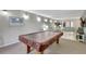 Relaxing game room with a covered pool table and comfortable seating area at 6157 Midnight Pass Rd # E65, Sarasota, FL 34242