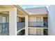 Exterior hallway featuring multiple levels with railings and neutral color scheme at 6157 Midnight Pass Rd # E65, Sarasota, FL 34242
