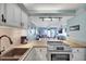 Bright kitchen with white cabinets, wood countertops, and an open view to the living room at 6157 Midnight Pass Rd # E65, Sarasota, FL 34242