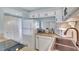 Well-equipped kitchen with white cabinets, countertops, and modern appliances at 6157 Midnight Pass Rd # E65, Sarasota, FL 34242