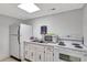 Functional kitchenette with essential appliances including a stove, microwave, and refrigerator at 6157 Midnight Pass Rd # E65, Sarasota, FL 34242