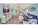 Open-concept living area with modern decor and seamless flow into dining and kitchen area, light and bright at 6157 Midnight Pass Rd # E65, Sarasota, FL 34242