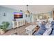 Open-concept living area with modern decor, stylish furniture, and seamless flow into adjacent dining and kitchen area at 6157 Midnight Pass Rd # E65, Sarasota, FL 34242