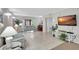 Comfortable living room with cozy couches, a TV, and bright lighting at 6157 Midnight Pass Rd # E65, Sarasota, FL 34242