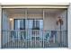 Cozy outdoor patio seating area with peaceful views of the community at 6157 Midnight Pass Rd # E65, Sarasota, FL 34242