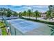 Well-maintained tennis court surrounded by lush greenery, perfect for an active lifestyle at 6157 Midnight Pass Rd # E65, Sarasota, FL 34242