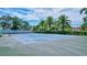 Well-maintained tennis court surrounded by lush greenery, perfect for an active lifestyle at 6157 Midnight Pass Rd # E65, Sarasota, FL 34242