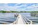 Scenic view from the pier showcasing the waterfront, palm trees and beautiful landscaping at 6157 Midnight Pass Rd # E65, Sarasota, FL 34242