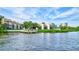Scenic waterfront view of condo buildings with a private dock extending into the water at 6157 Midnight Pass Rd # E65, Sarasota, FL 34242