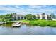 Beautiful waterfront view of condo buildings, private dock and well-maintained green spaces at 6157 Midnight Pass Rd # E65, Sarasota, FL 34242