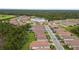 A residential community surrounded by beautiful Florida landscape and tile roofs at 620 Nasturtium Ct, Nokomis, FL 34275