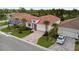 A birds-eye view of a house showcasing its red tile roof, landscaping, and brick paver driveway at 620 Nasturtium Ct, Nokomis, FL 34275