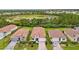 A neighborhood with a scenic pond and houses with beautiful red tile roofs and brick paver driveways at 620 Nasturtium Ct, Nokomis, FL 34275
