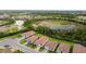 A view of a residential community, showing lush green landscaping and beautiful tile roofs at 620 Nasturtium Ct, Nokomis, FL 34275