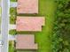 Aerial view of roofs and green lawns with privacy bushes at 620 Nasturtium Ct, Nokomis, FL 34275
