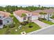 Aerial view of a home showcasing its red tile roof, landscaping, and brick paver driveway at 620 Nasturtium Ct, Nokomis, FL 34275