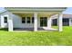 A covered patio featuring brick flooring and a beautiful view of the lush green lawn at 620 Nasturtium Ct, Nokomis, FL 34275