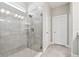 Bathroom with a glass shower, white cabinets, and a modern shower fixture at 620 Nasturtium Ct, Nokomis, FL 34275