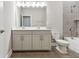 Bathroom boasts double sinks, large mirror, and tiled tub at 620 Nasturtium Ct, Nokomis, FL 34275