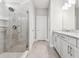 Bathroom featuring a glass enclosed shower with tile surround and double sink vanity at 620 Nasturtium Ct, Nokomis, FL 34275