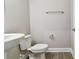 Powder room features pedestal sink and grey plank flooring at 620 Nasturtium Ct, Nokomis, FL 34275