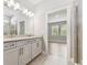 Bathroom view from vanity into glass shower with an adjoining bedroom at 620 Nasturtium Ct, Nokomis, FL 34275