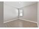 Bright bedroom with a window, new gray paint, white baseboards, and wood-look tiled floor at 620 Nasturtium Ct, Nokomis, FL 34275