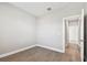 Empty bedroom featuring wood-look tile flooring, neutral walls, and white trim and an open doorway at 620 Nasturtium Ct, Nokomis, FL 34275