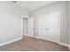 Bedroom features a closet and wood-look tile flooring at 620 Nasturtium Ct, Nokomis, FL 34275