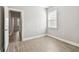 Bedroom features a window and light-colored wood-look tile flooring at 620 Nasturtium Ct, Nokomis, FL 34275