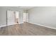 Empty bedroom with wood-look tile flooring and white doors leading to other rooms at 620 Nasturtium Ct, Nokomis, FL 34275