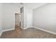 Newly painted bedroom features a wood-look tiled floor, white door, and access to an ensuite bathroom at 620 Nasturtium Ct, Nokomis, FL 34275