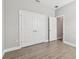 Bedroom features a closet and wood-look tile flooring at 620 Nasturtium Ct, Nokomis, FL 34275
