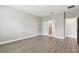 Empty bedroom with wood-look tile flooring, white doors and neutral paint at 620 Nasturtium Ct, Nokomis, FL 34275