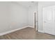 Bedroom with gray paint and wood-look tiled floor; features an interior door and a closet at 620 Nasturtium Ct, Nokomis, FL 34275