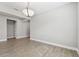 Dining room features wood-look tile flooring, gray paint, white baseboards, and a modern light fixture at 620 Nasturtium Ct, Nokomis, FL 34275