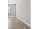Dining room features wood-look tile flooring, gray paint, baseboards, and a modern chandelier at 620 Nasturtium Ct, Nokomis, FL 34275