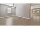 A dining room with wood-look tile flooring, new neutral paint, a modern light fixture, and a bright window at 620 Nasturtium Ct, Nokomis, FL 34275