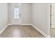 An empty room with a tile floor, neutral walls, and a front door with decorative glass detail at 620 Nasturtium Ct, Nokomis, FL 34275