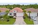 An aerial view of a charming single-story home with a terracotta tile roof and manicured landscaping at 620 Nasturtium Ct, Nokomis, FL 34275