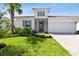 Charming home featuring stone accents, a well-manicured lawn, and a paver driveway at 620 Nasturtium Ct, Nokomis, FL 34275