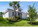 Well-maintained home exterior with stone detailing, a side-entry garage, and lush landscaping at 620 Nasturtium Ct, Nokomis, FL 34275