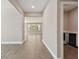 Hallway features tile floors, neutral paint, and views of the open-concept living spaces with natural light at 620 Nasturtium Ct, Nokomis, FL 34275