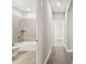Hallway view showing access to bathroom with tiled shower and tub at 620 Nasturtium Ct, Nokomis, FL 34275